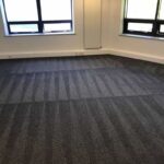 This is a photo of a grey office carpet that has just been professionally steam cleaned works carried out by Belsize Park Carpet Cleaning Solutions