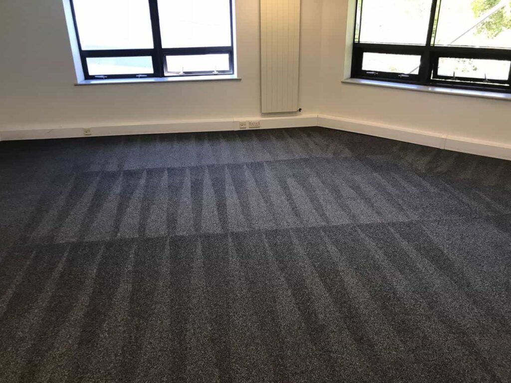 This is a photo of a grey office carpet that has just been professionally steam cleaned works carried out by Belsize Park Carpet Cleaning Solutions