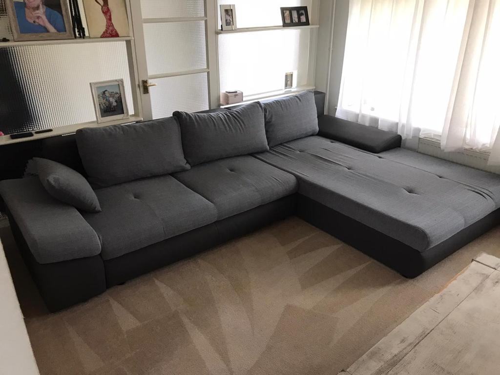 This is a photo of a grey L shape sofa that has been professionally steam cleaned, also the beige carpets have been steam cleaned too works carried out by Belsize Park Carpet Cleaning Solutions