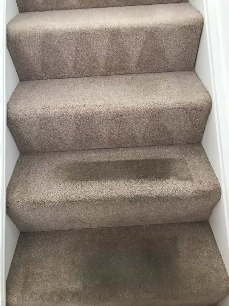 this is a photo of a staircase with beige carpets that is in the process of being cleaned works carried out by Belsize Park Carpet Cleaning Solutions